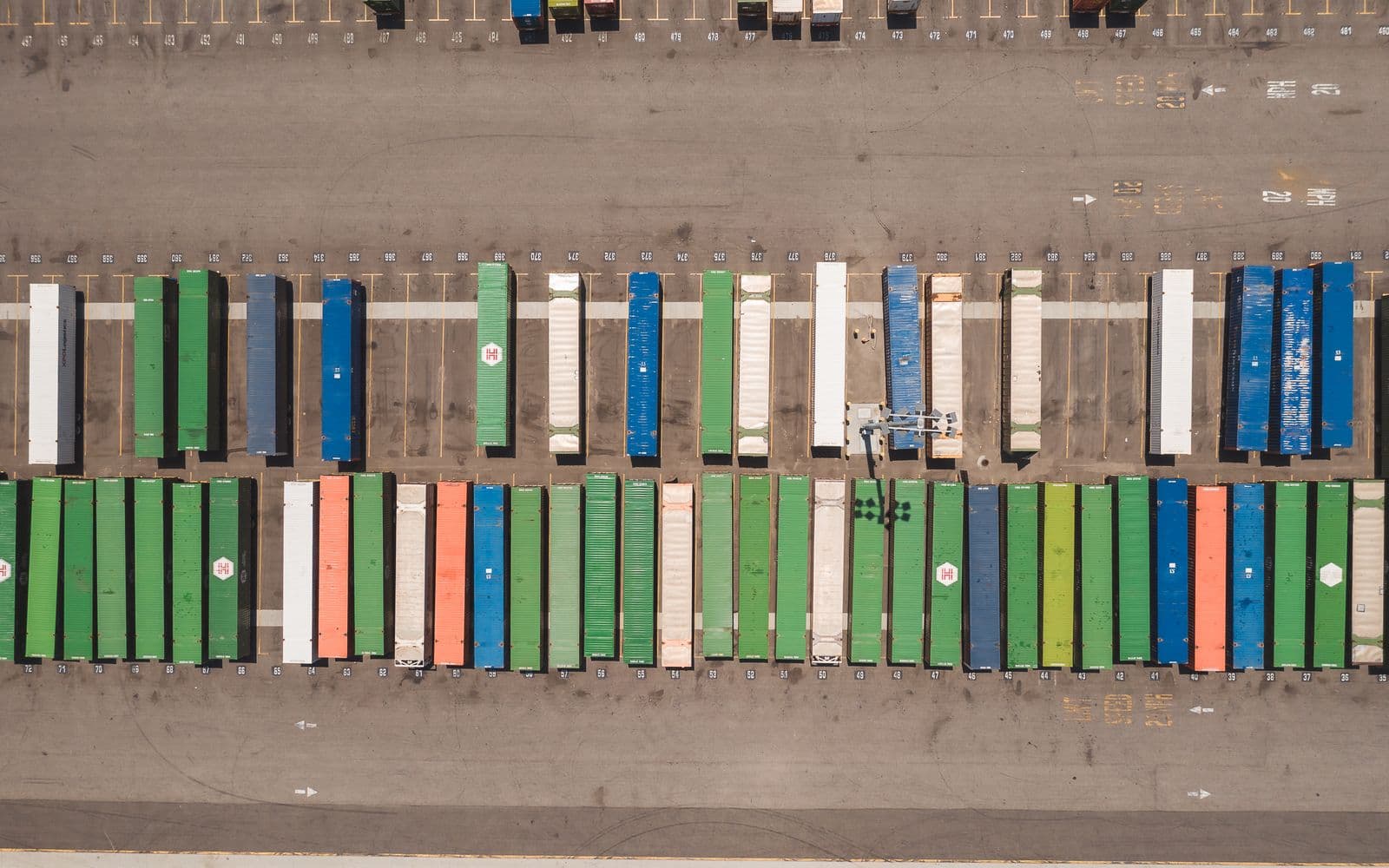 Top view of neatly arranged cargo containers in a shipping port, highlighting logistics and global trade